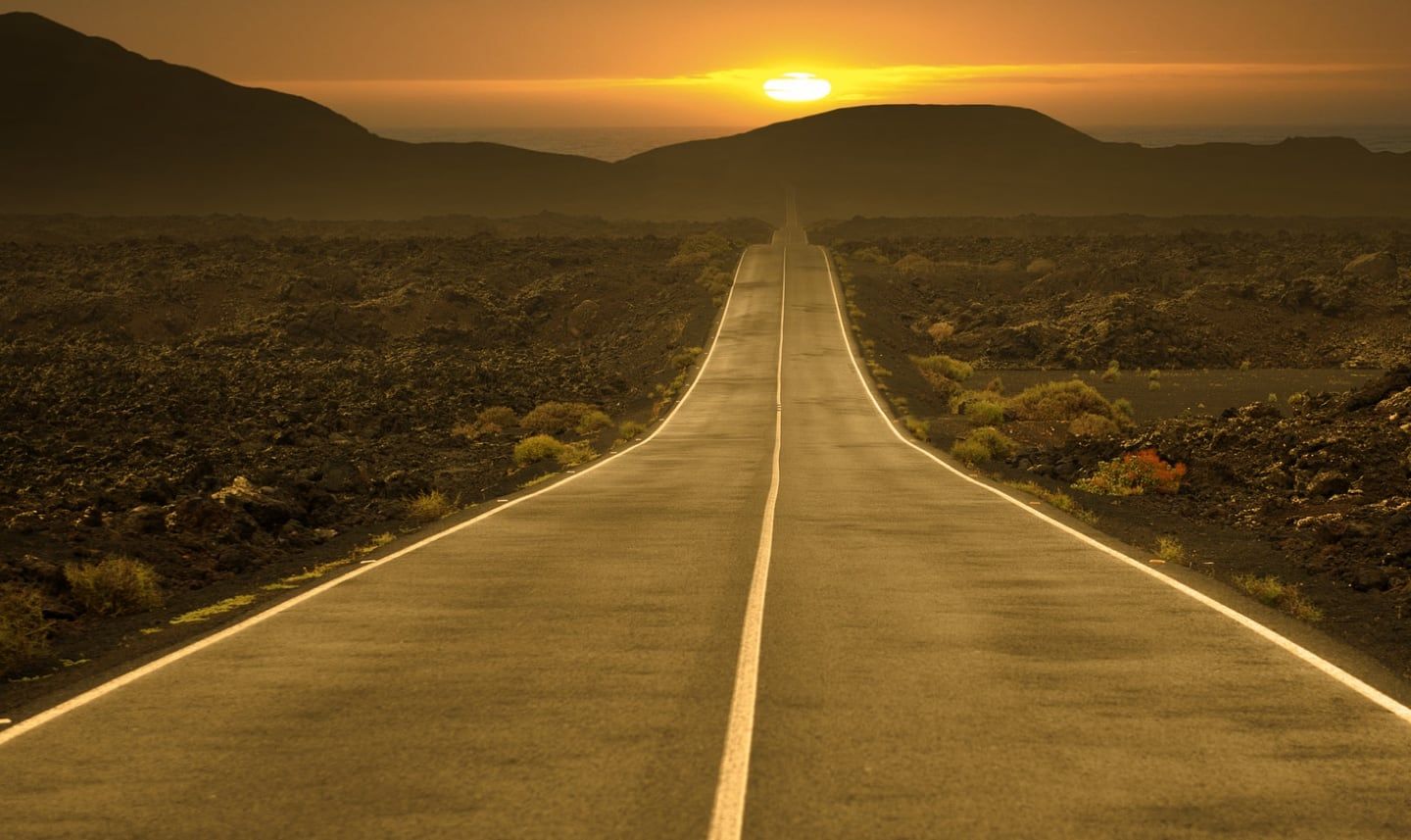 Open road at sunset, symbolizing the personal fitness journey and transformation at Fortitude Fitness